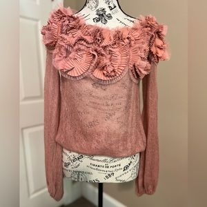Pink sheer top with flowers at the top